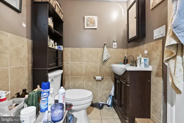 a white toilet sitting next to a bathroom sink