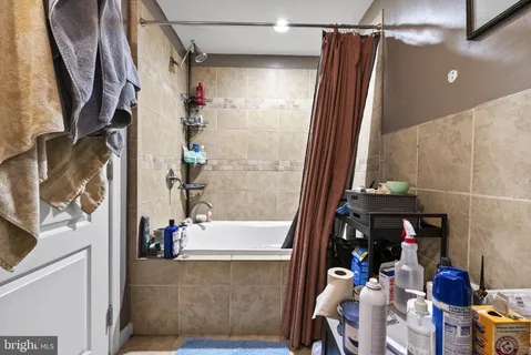 a bathroom with a bathtub and shower