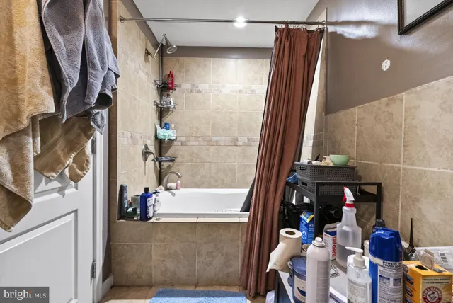 a bathroom with a bathtub and shower