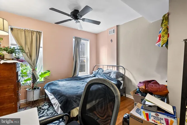 a bed room with a bed and a chair