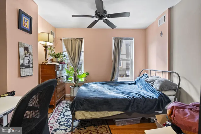 a bedroom with bed and a chandelier