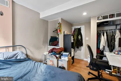 a living room with furniture gym equipment and wooden floor