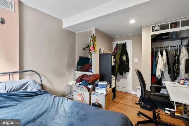 a living room with furniture gym equipment and wooden floor