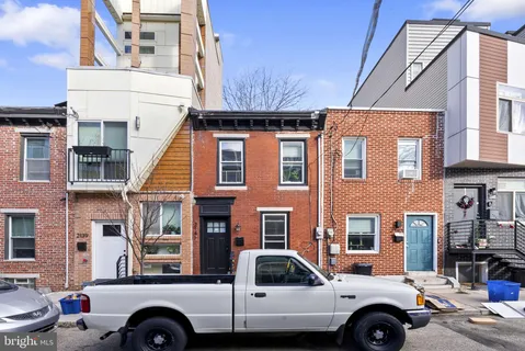 a front view of a house with parking space