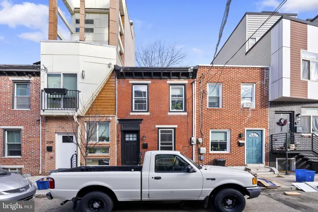 a front view of a house with parking space