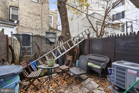 a view of a chairs and table in the back yard of the house