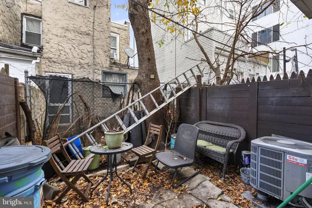 a view of a chairs and table in the back yard of the house