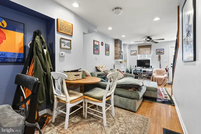 a living room with furniture a flat screen tv and a table