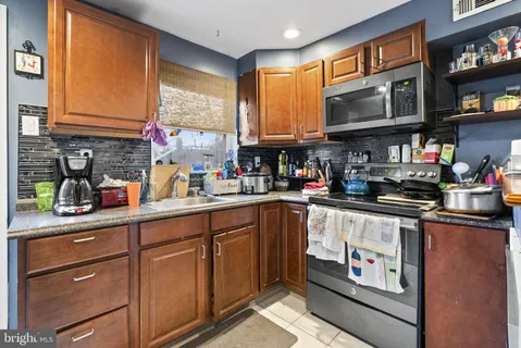 a kitchen with stainless steel appliances granite countertop a sink and cabinets