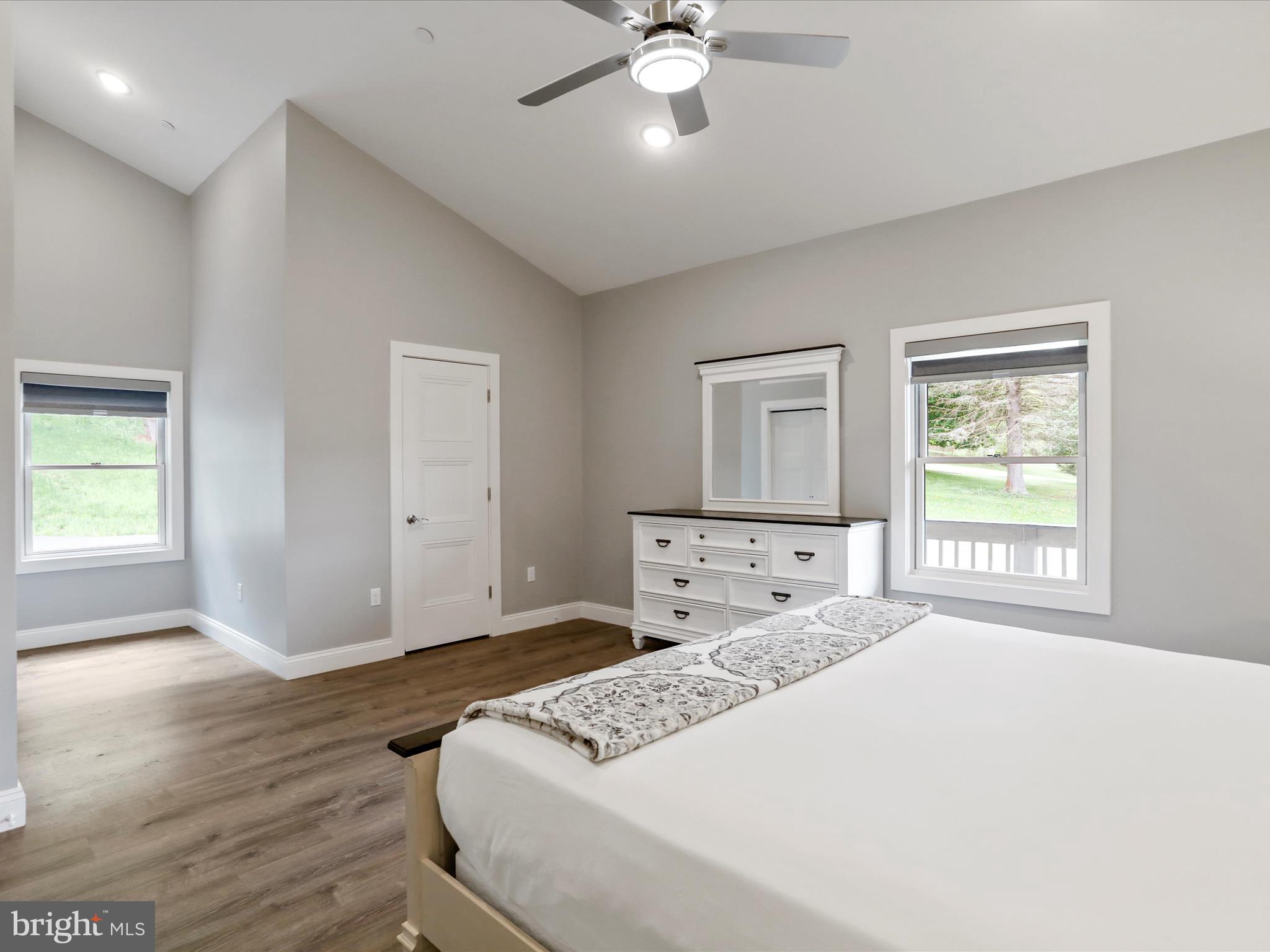 215 Fair Gate Road McHenry, MD 21541 - Photo 17 of 52 a spacious bedroom with a large bed and a window