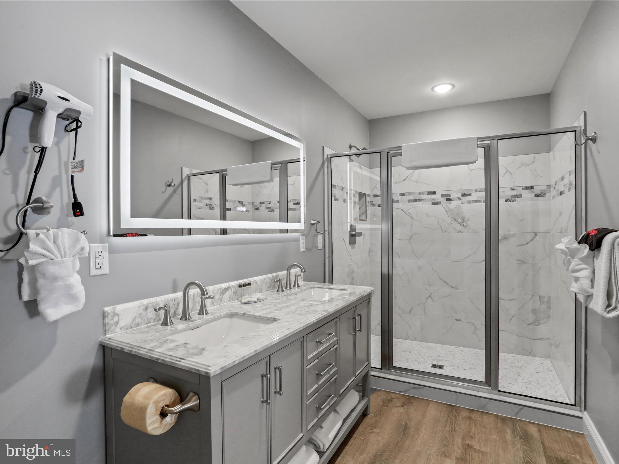 215 Fair Gate Road McHenry, MD 21541 - Photo 19 of 52 a bathroom with a granite countertop sink a mirror and a shower