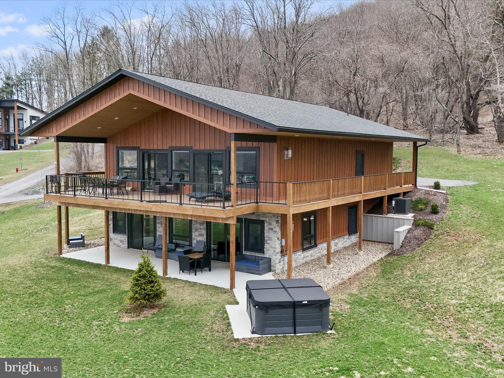 215 Fair Gate Road McHenry, MD 21541 - Photo 3 of 52 a front view of a house with a yard table and chairs