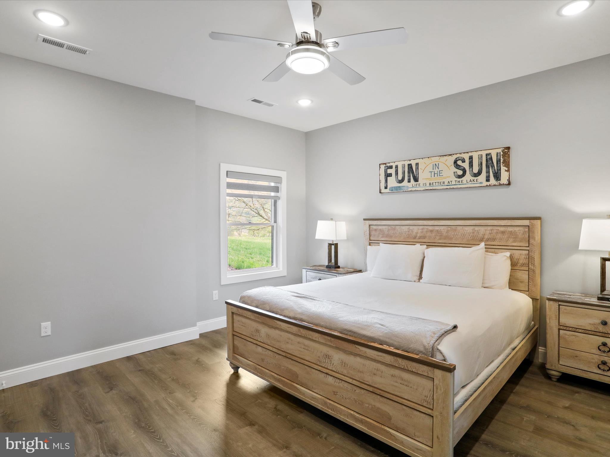 215 Fair Gate Road McHenry, MD 21541 - Photo 35 of 52 a bedroom with a bed and a chandelier