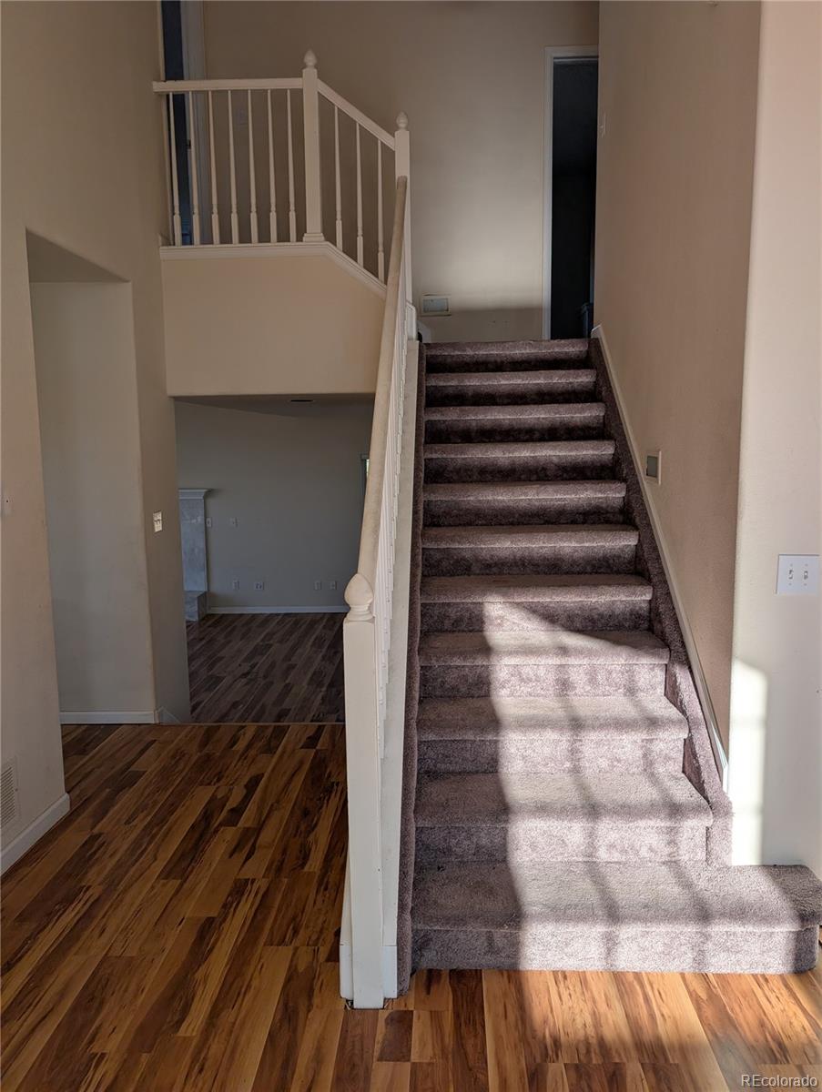 43882 Buckskin Road Parker, CO 80138 - Photo 12 of 19 a view of entryway and hall with wooden floor