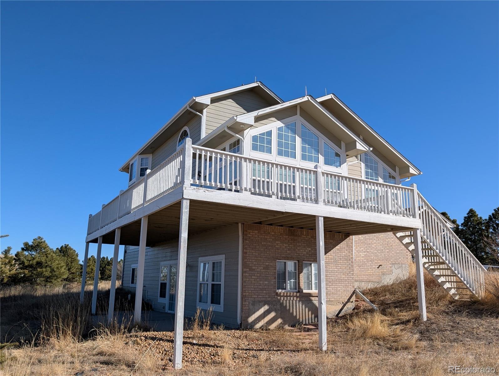 43882 Buckskin Road Parker, CO 80138 - Photo 2 of 19 a front view of a house with garden