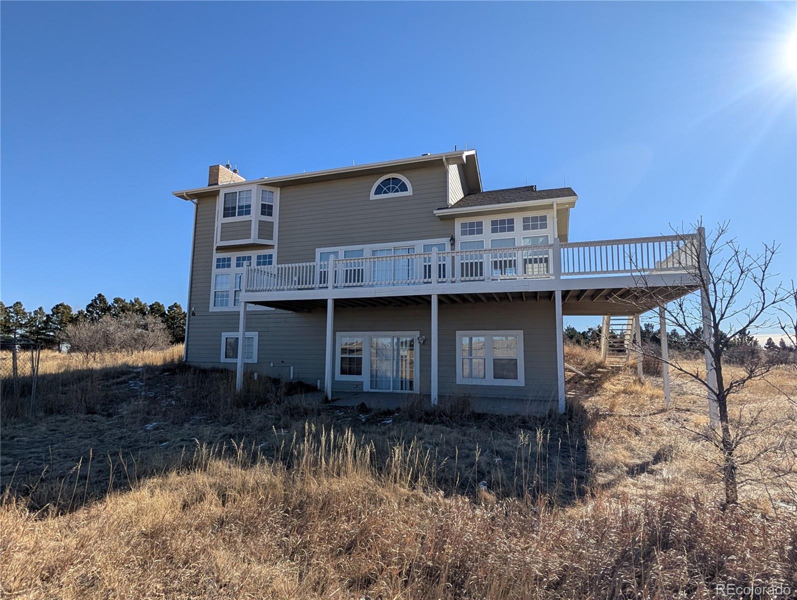 43882 Buckskin Road Parker, CO 80138 - Photo 3 of 19 a front view of a house with a yard