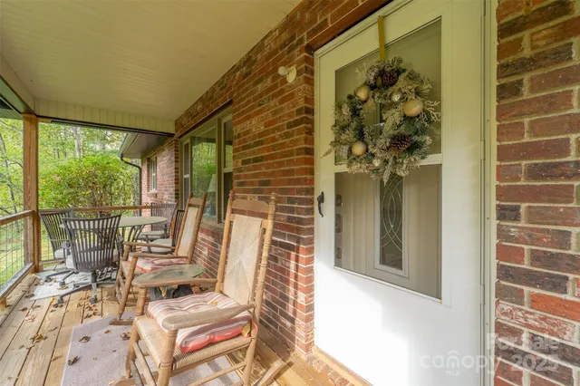 a view of balcony with wooden floor and outdoor seating