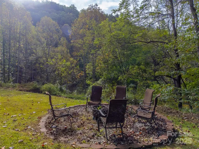 a view of a chair and table in backyard of the house