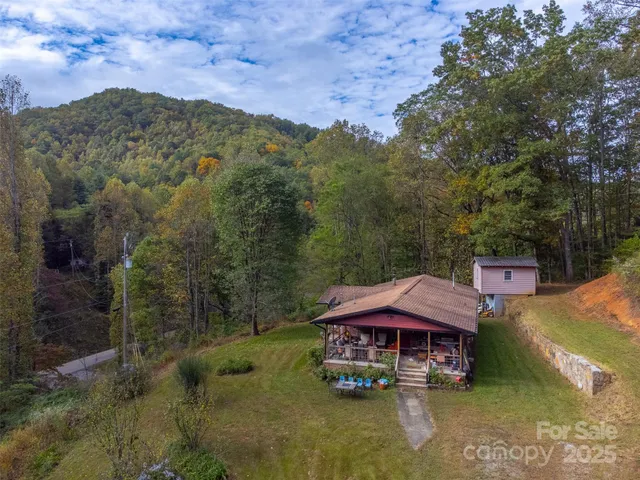 an aerial view of a house with a yard