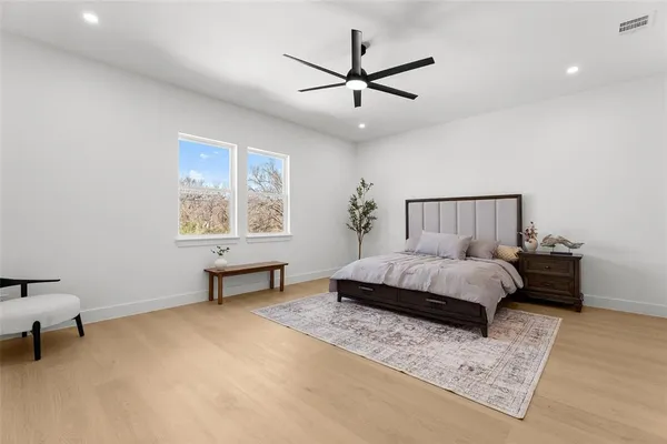 a spacious bedroom with a bed and a window