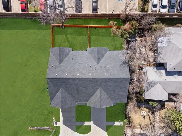 an aerial view of a house with a yard