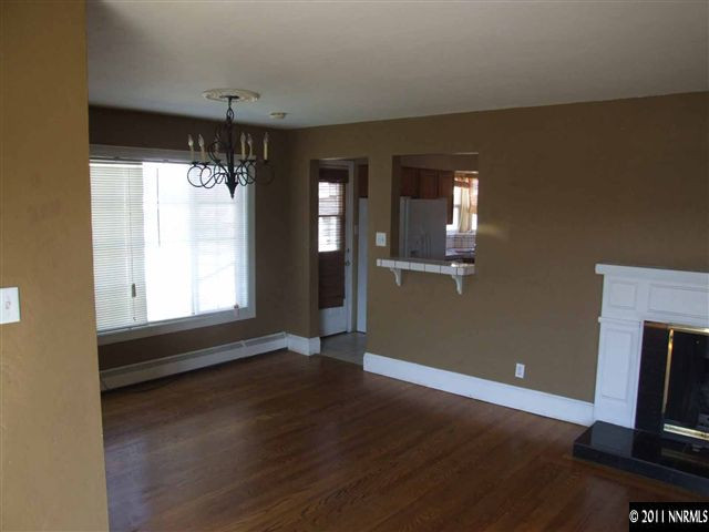 805 Roberts Street Reno, NV 89502 - Photo 3 of 9 an empty room with wooden floor and windows