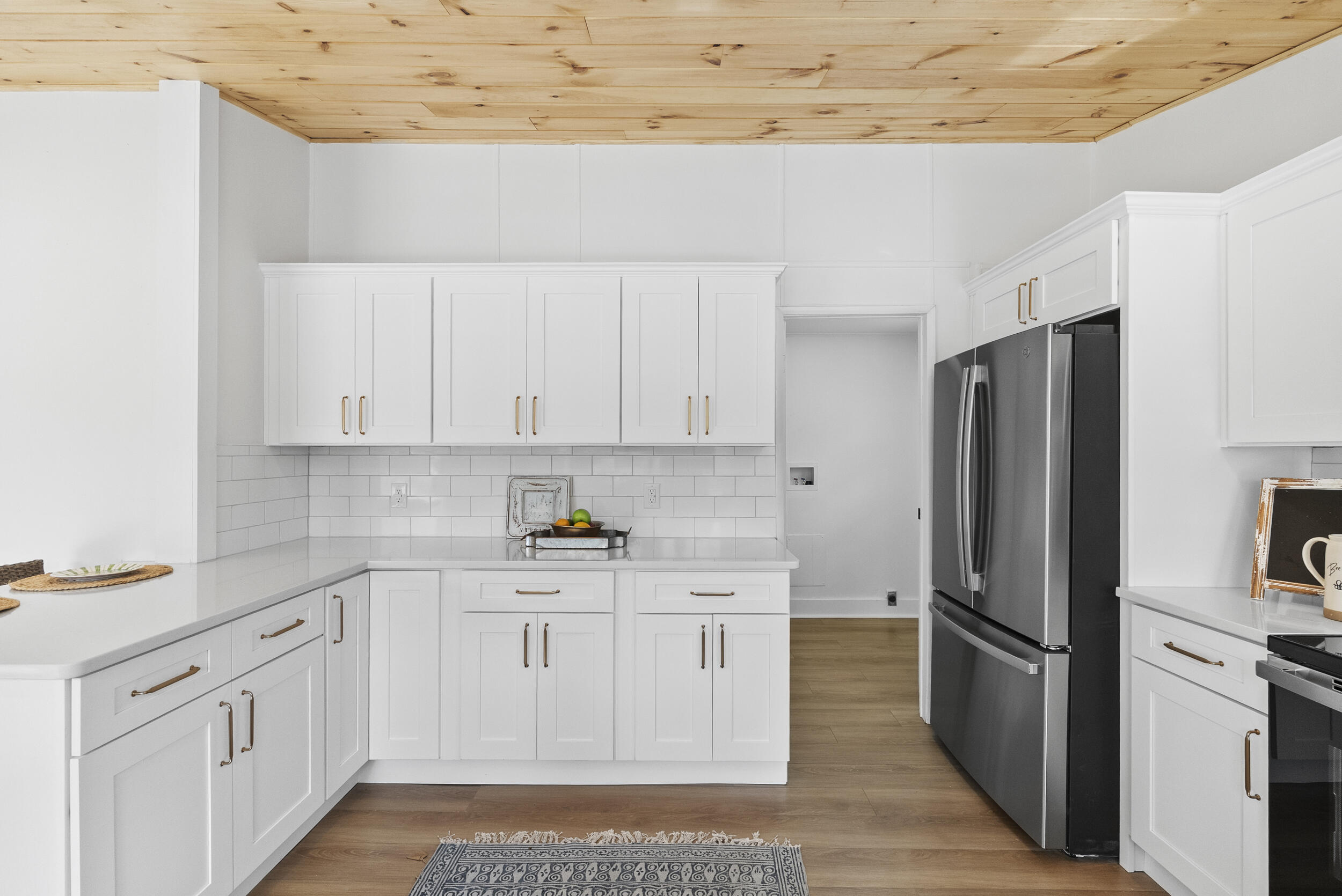 509 Pleasure Point Drive Goodview, VA 24095 - Photo 12 of 38 a kitchen with white cabinets and stainless steel appliances