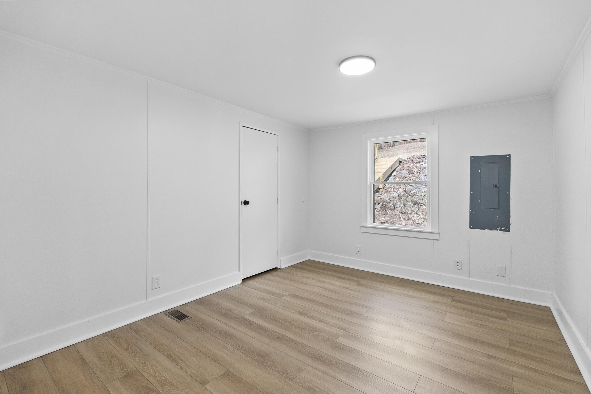 509 Pleasure Point Drive Goodview, VA 24095 - Photo 17 of 38 an empty room with wooden floor and windows