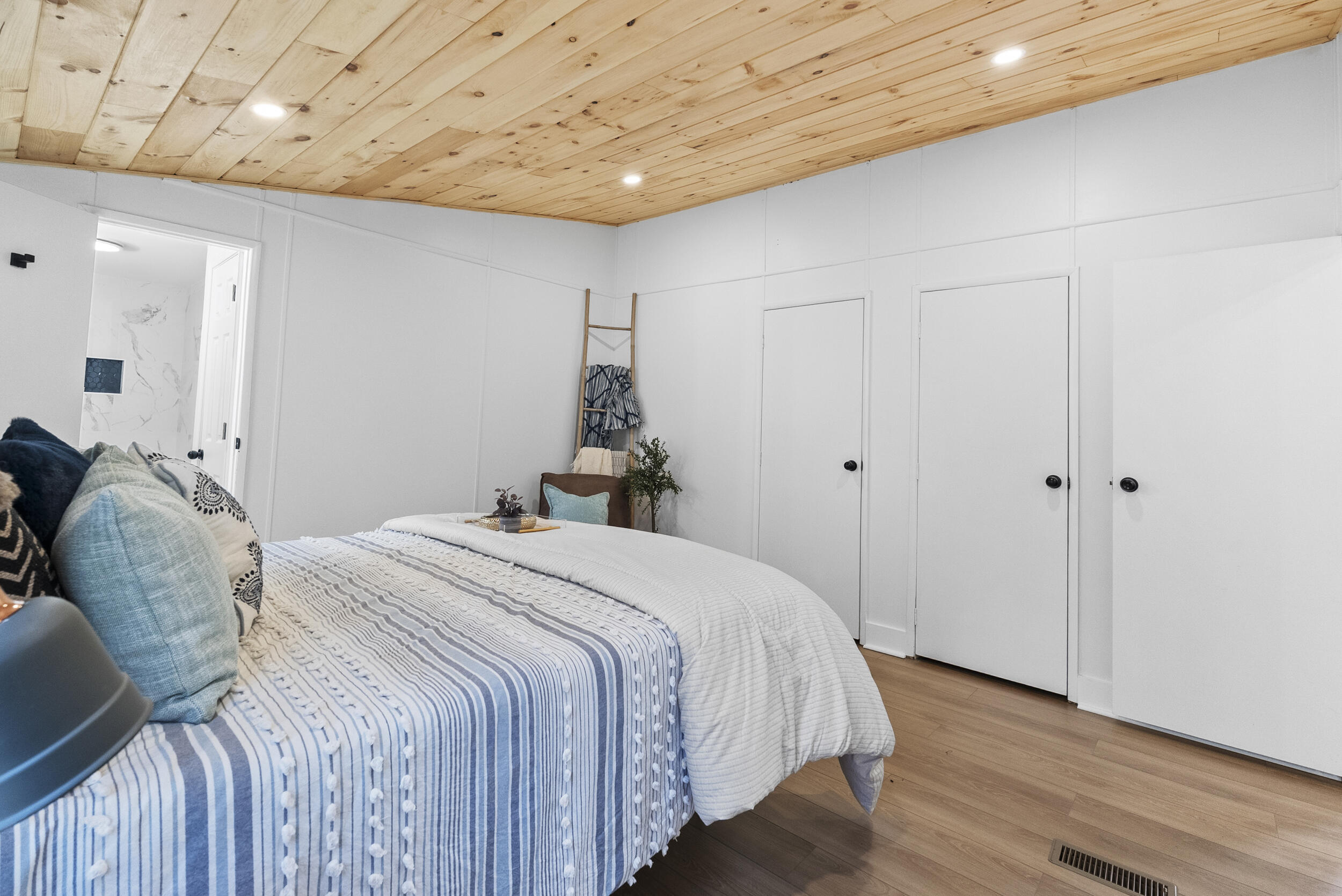 509 Pleasure Point Drive Goodview, VA 24095 - Photo 19 of 38 a bedroom with a bed and a chandelier