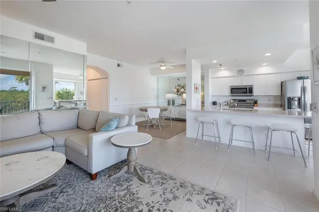 a dining room with furniture a rug and a chandelier