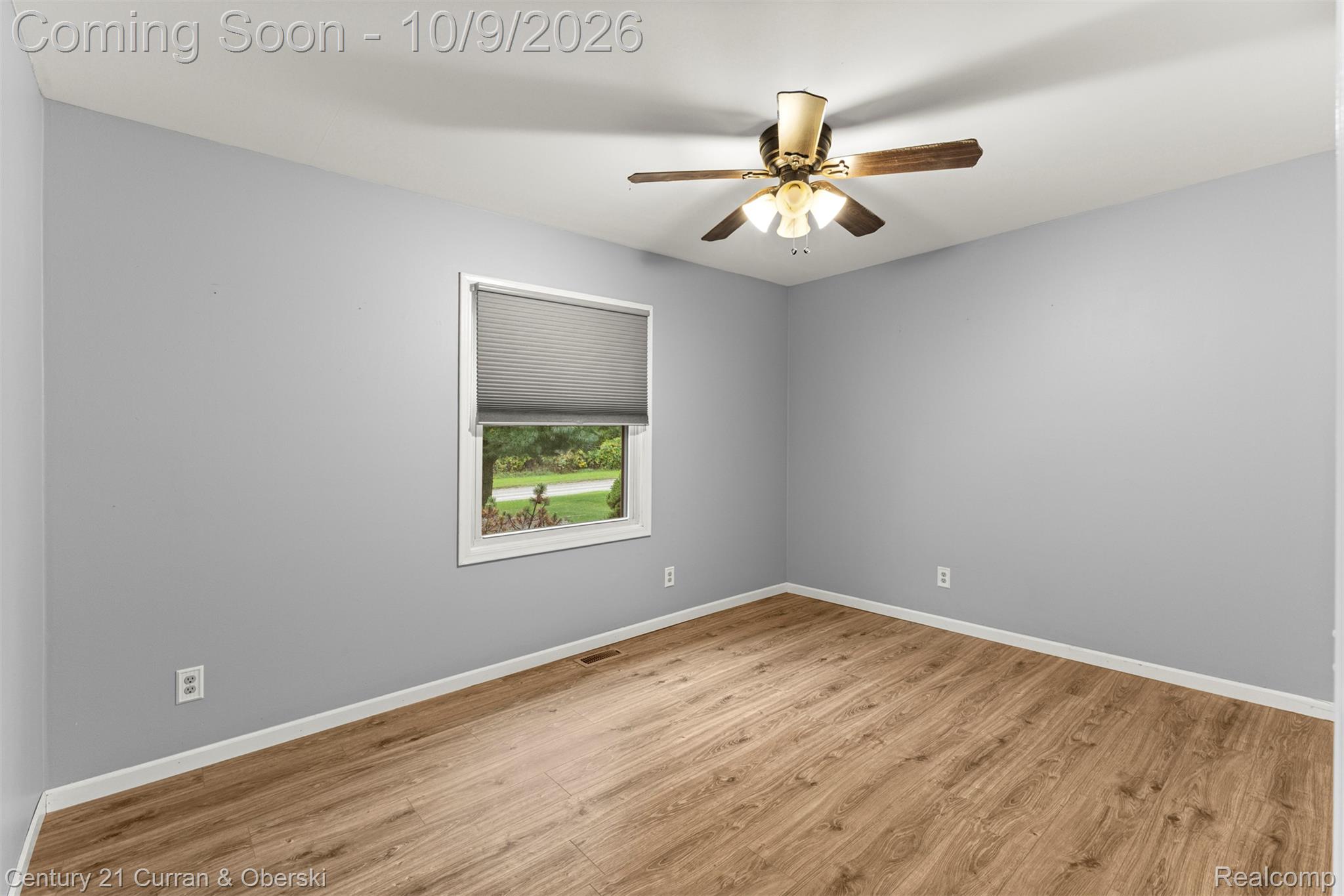43040 Willis Road Belleville, MI 48111 - Photo 21 of 65 Recessed window with privacy blind, wood-finish flooring, ceiling fan with integrated lighting, and neutral wall color