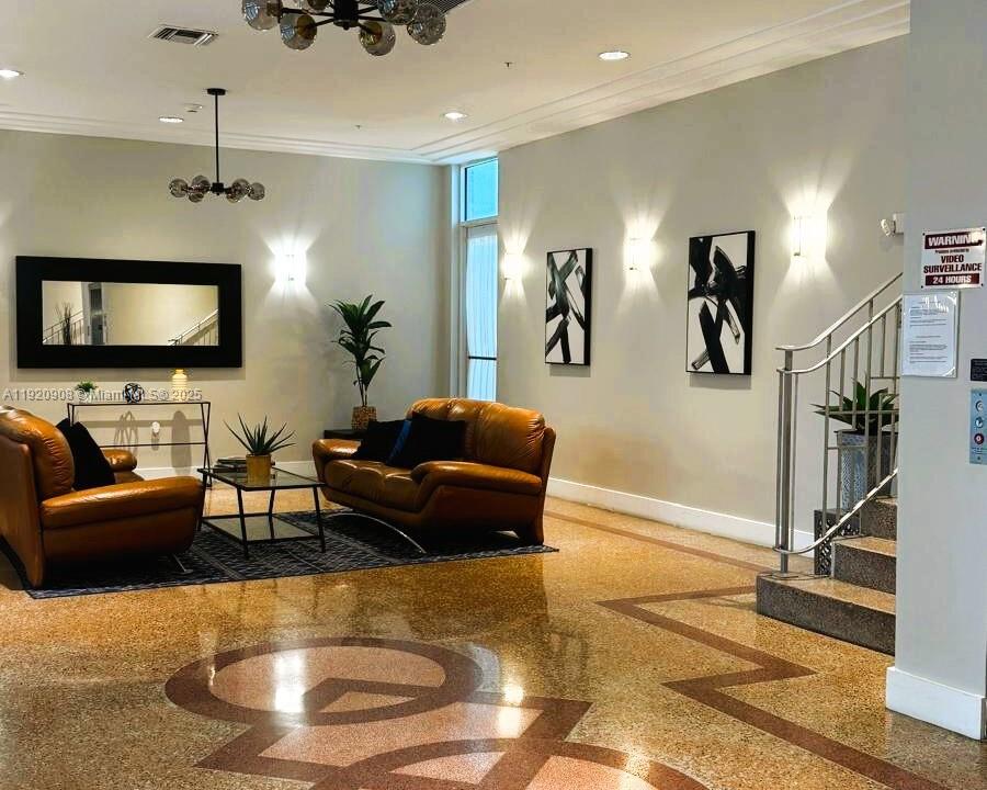 7326 Collins Avenue, Unit 205 Miami Beach, FL 33141 - Photo 13 of 15 a living room with furniture and a flat screen tv