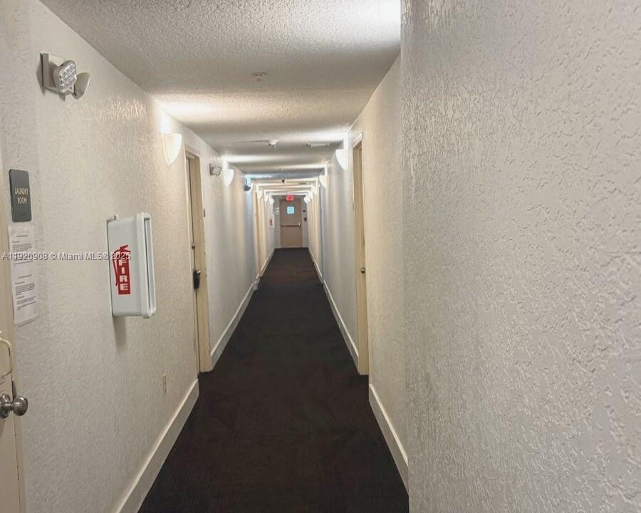 7326 Collins Avenue, Unit 205 Miami Beach, FL 33141 - Photo 14 of 15 a view of hallway with stairs