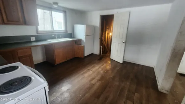 a view of a kitchen with a sink cabinets and a window