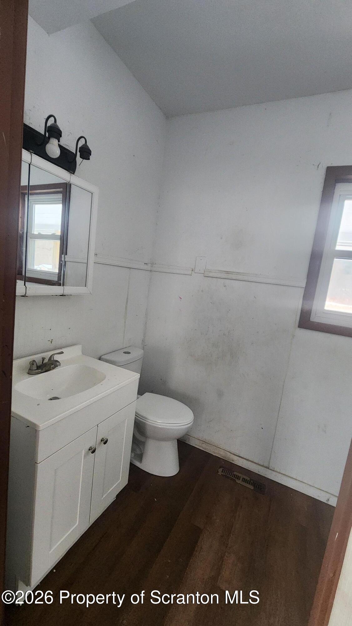 446 Main Street Hallstead, PA 18822 - Photo 12 of 51 a bathroom with a toilet sink and mirror