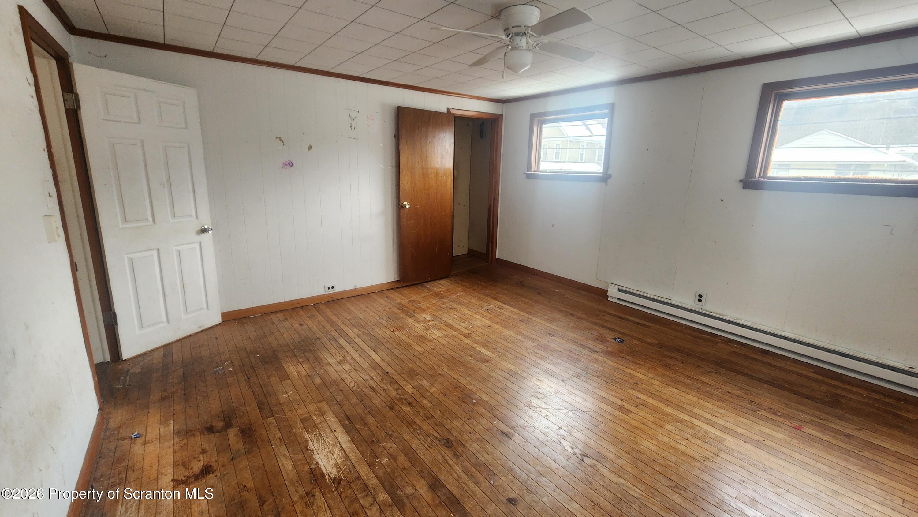 446 Main Street Hallstead, PA 18822 - Photo 18 of 51 an empty room with wooden floor and windows