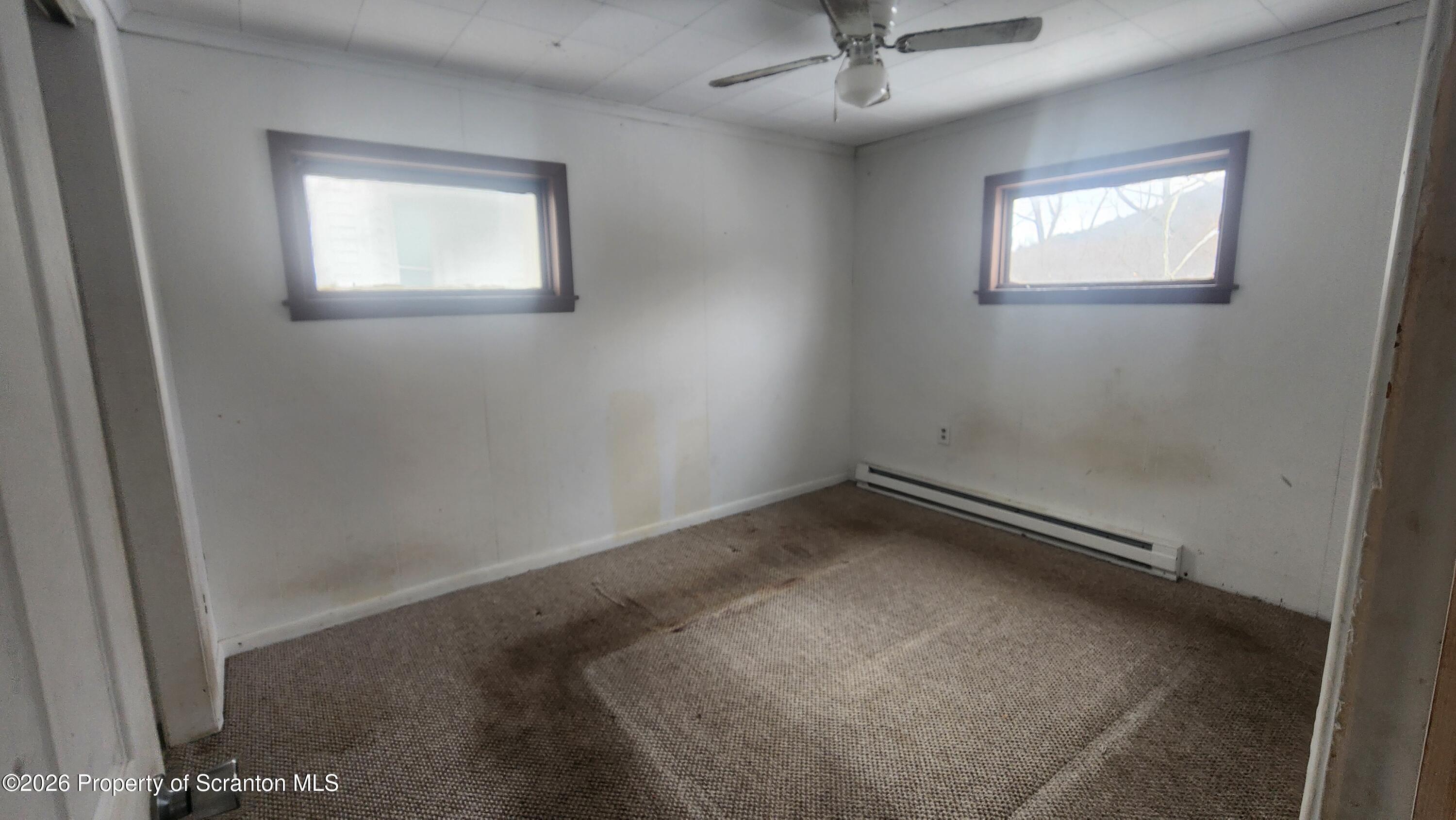 446 Main Street Hallstead, PA 18822 - Photo 22 of 51 an empty room with a window and a ceiling fan