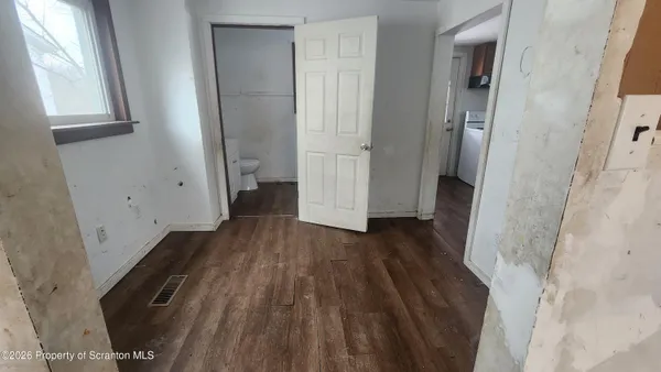 a view of hallway with wooden floor