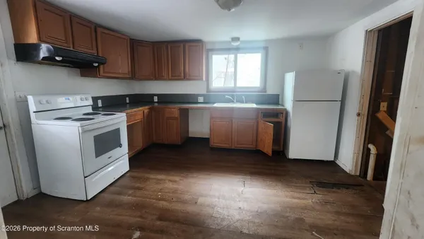 a kitchen with stainless steel appliances granite countertop a refrigerator a sink a stove a microwave and cabinets