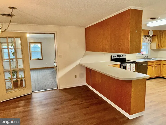 a kitchen with stainless steel appliances granite countertop a sink stove and cabinets