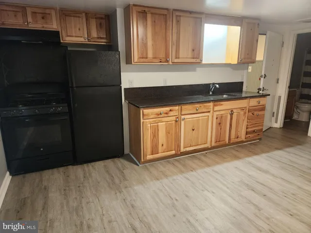 a view of a kitchen with a sink cabinets and wooden floor