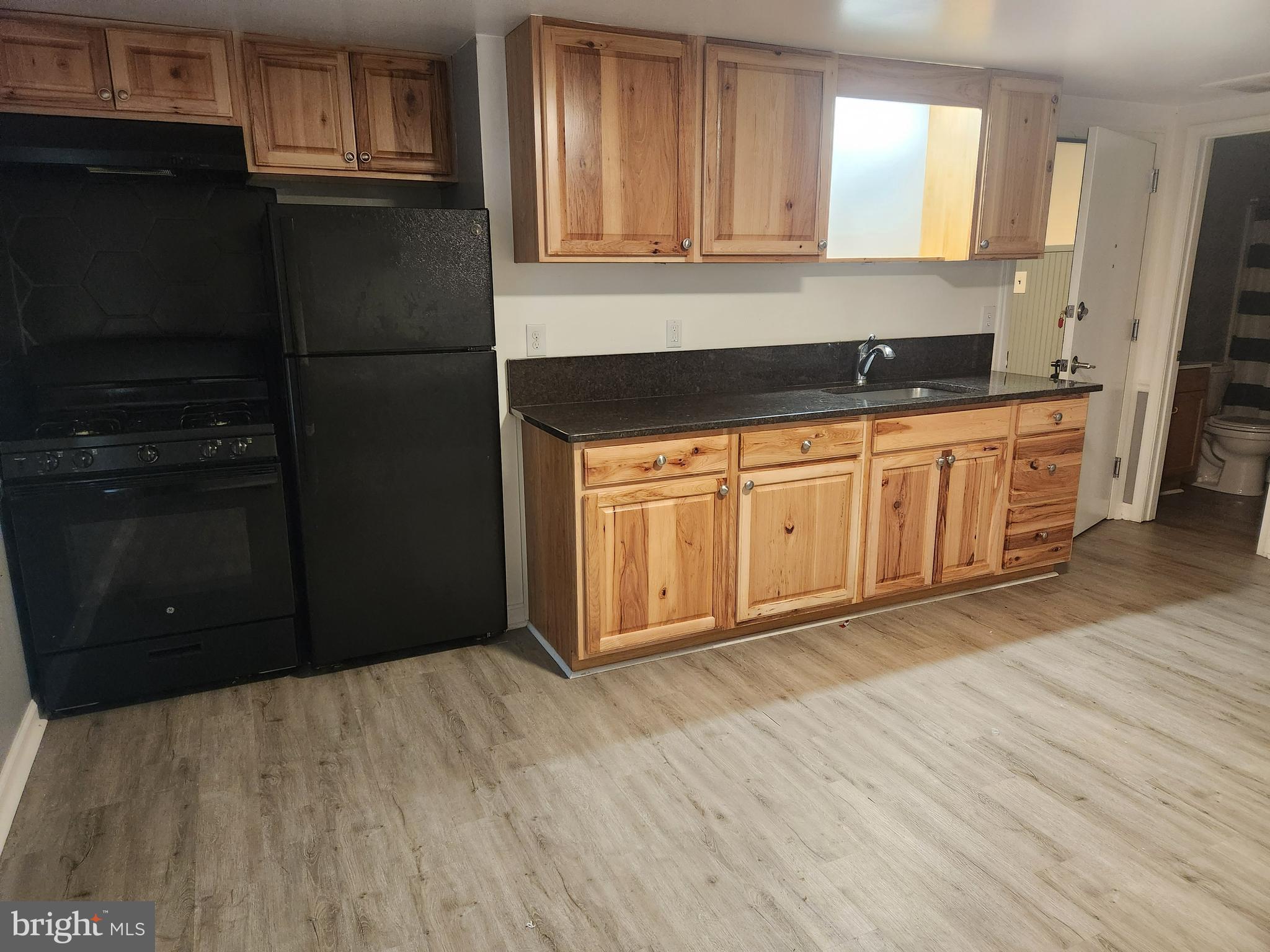 51 Ed Turner Lane, Unit 201 Harpers Ferry, WV 25425 - Photo 2 of 6 a view of a kitchen with a sink cabinets and wooden floor