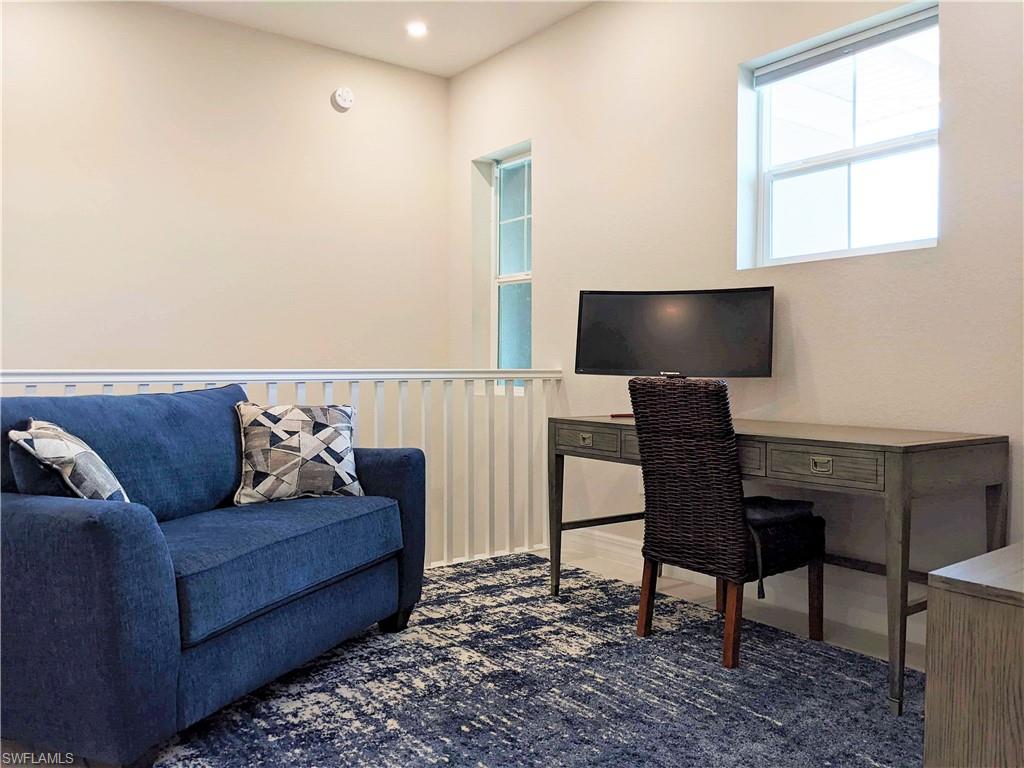 178 Indies Drive East, Unit 201 Naples, FL 34114 - Photo 14 of 31 a living room with furniture and a flat screen tv