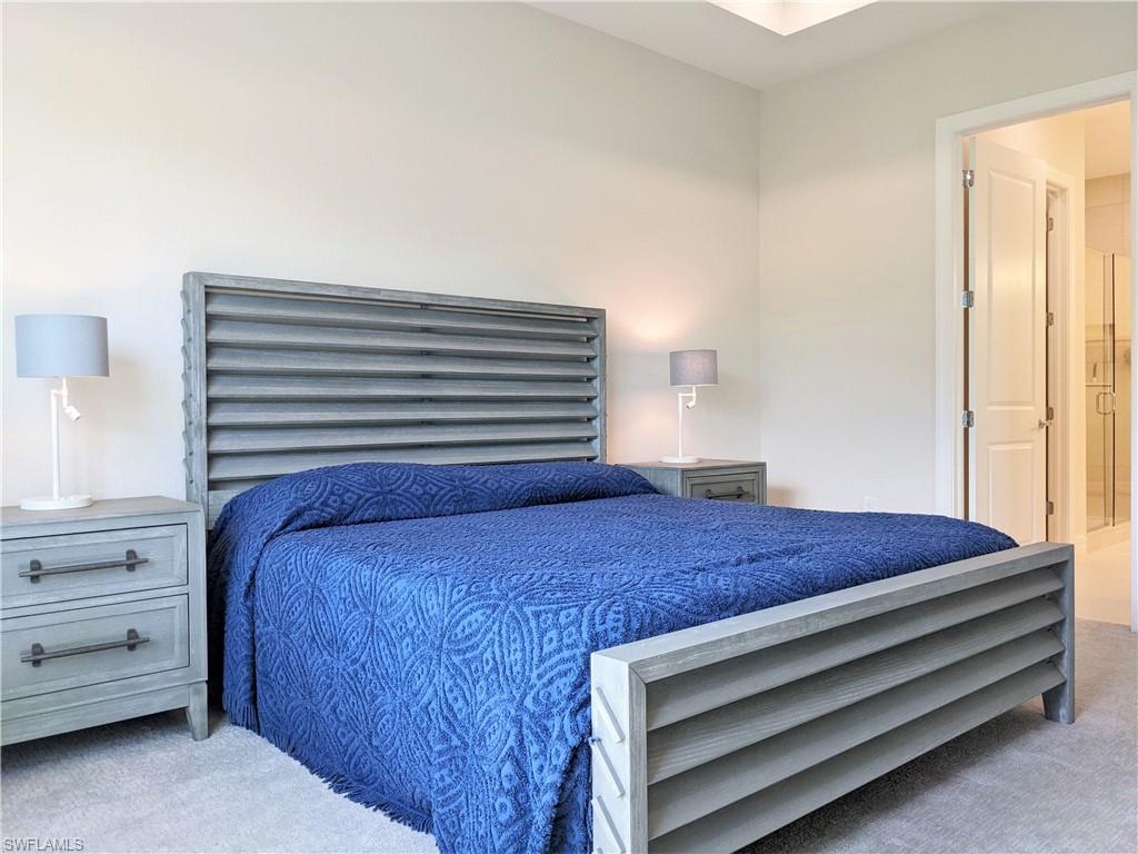 178 Indies Drive East, Unit 201 Naples, FL 34114 - Photo 15 of 31 a bedroom with a bed and a window