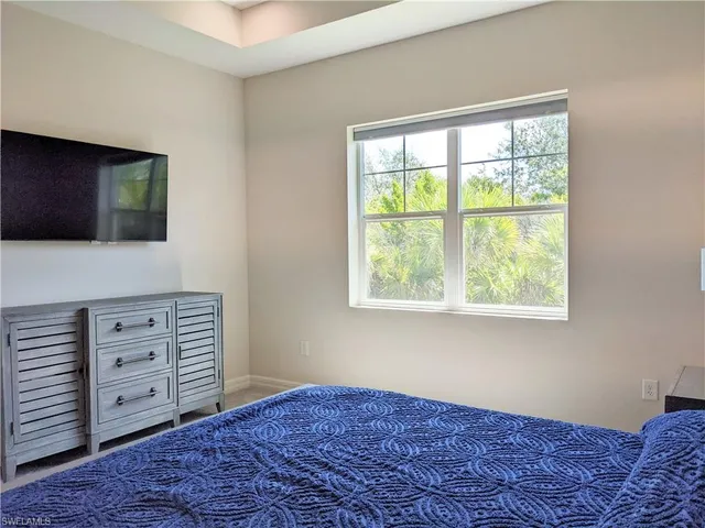 a bedroom with a bed and a television