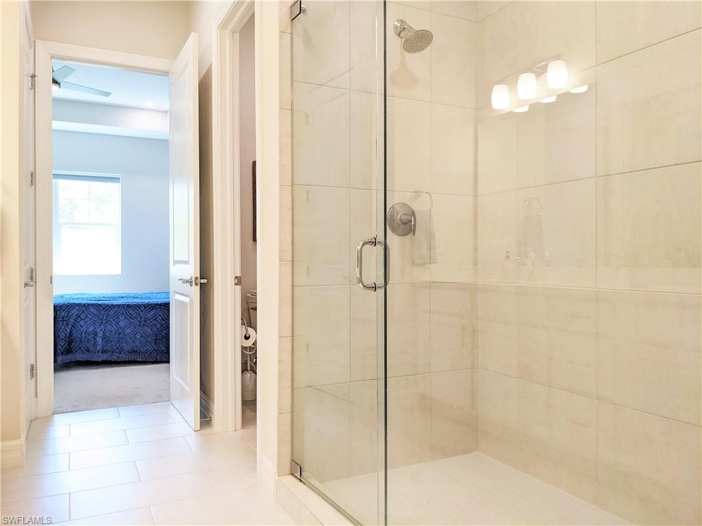 178 Indies Drive East, Unit 201 Naples, FL 34114 - Photo 18 of 31 a bathroom with a shower