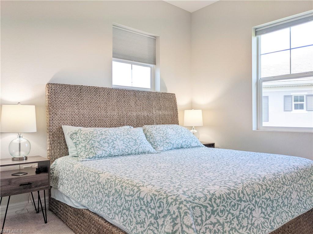 178 Indies Drive East, Unit 201 Naples, FL 34114 - Photo 20 of 31 a bedroom with a bed and a window