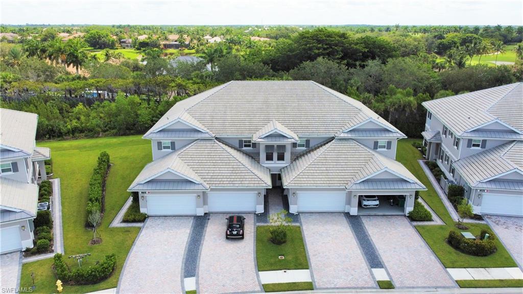 178 Indies Drive East, Unit 201 Naples, FL 34114 - Photo 2 of 31 an aerial view of a house with a yard