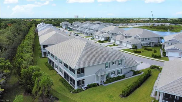 an aerial view of a house with a garden and lake view