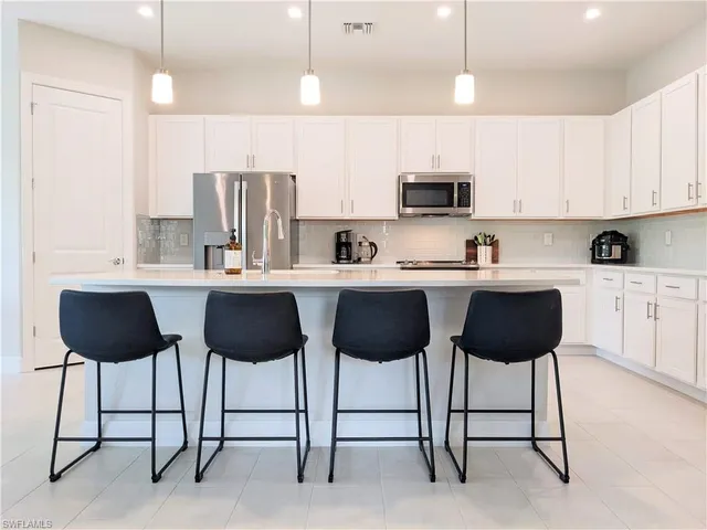 a kitchen with stainless steel appliances a sink and cabinets